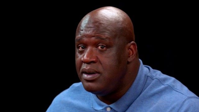 Shaq Tries to Not Make a Face While Eating Spicy Wings